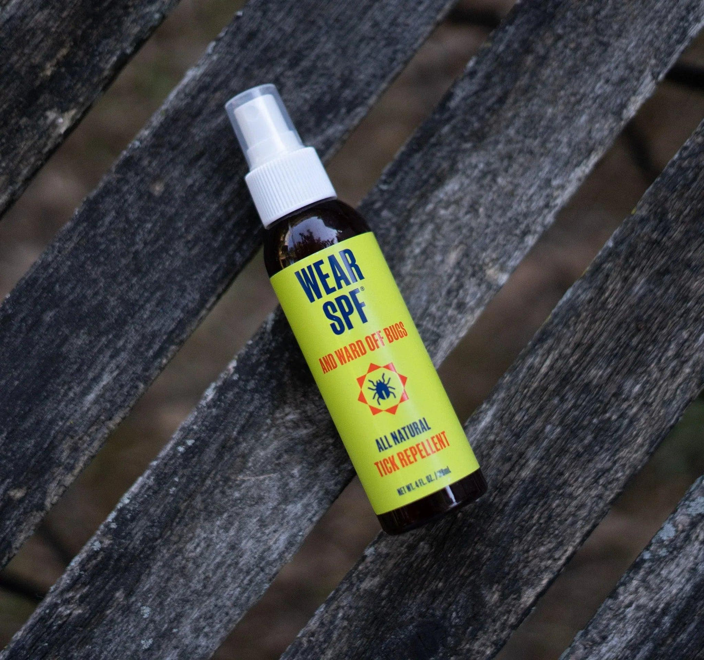 WearSPF-Tick-Spray-on-wood - GOLF LEAGUE